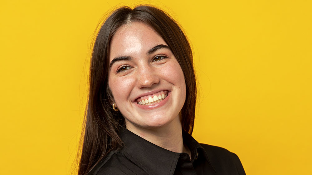 Headshot of Catie Plank smiling, looking over her right shoulder